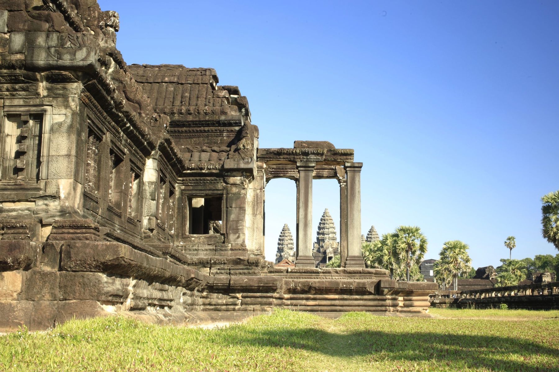 A stone gallery at Angkor Wat, with the central towers beyond